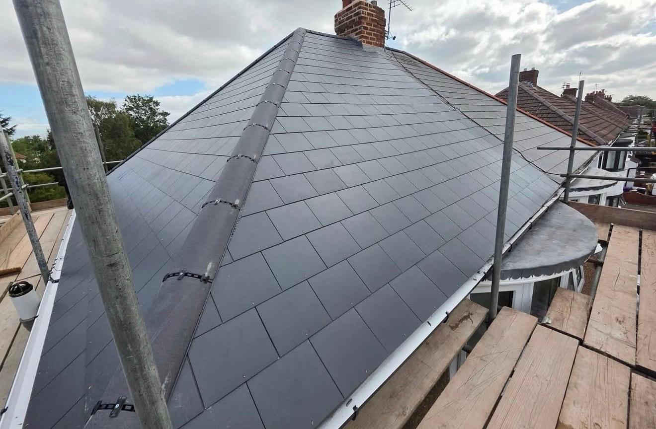 Completed slate re-roof with finished ridge and verge details